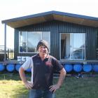 Ian Horsham stands in front of his houseboat in 2022. Now it sits on the back of a truck as Mr...