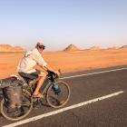 James Beatty riding through the desert in Sudan where temperatures would reach about 50 deg C....