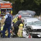 Emergency services work to extract the driver of a car involved in a collision with a truck in...