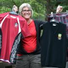 Logan Park High School uniform shop saleswoman Claire Metcalfe holds up a range of the school’s...