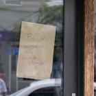 A sign on a shop window in Alexandra shows customers it is closed due to the power outage,...