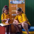 Willow Logavatu (left), 5, and Aaliyah Nehoff, 11, read a book together in the reopened Ardgowan...