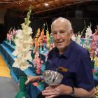 Doug Dixey, of Gore, holds the cup for the best gladioli at the Gore Garden Club Harvest Show on...