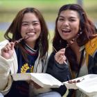 University of Otago students Noa Isip (left), 22, and Hanna Corre, 24, eat Philippine barbecue...