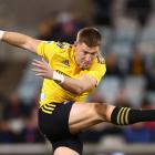 Jordie Barrett of the Hurricanes kicks ahead during a match last year. Photo: Getty Images 