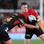 Dallas McLeod is tackled during the round one Super Rugby Pacific match against the Chiefs in...