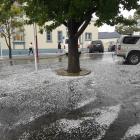 Pedestrians watch where they walk in Skird St after a hailstorm this afternoon. Photo: Julie Asher 