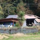 All that remains of a suspicious house fire in Waikaia is part of the garage and a lean-to which...