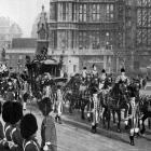 King George V arrives at Westminster aboard the State Coach to open the British parliament. —...