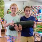 Holly Paterson and Flora Philippa (both 8) carry a large marrow between them at the Kurow and...