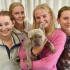Enjoying a hug with Lola are Unicol students (from left) Ruby Young, Greer Tremain, Matilda...