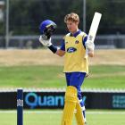 Otago batter Luke Georgeson celebrates after bringing up his century with a four in the Ford...
