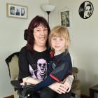 Dunedin mother Lara Elliot sits in her wheelchair with her daughter, Amelia, on her lap. PHOTO:...