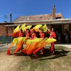The Dunedin Culture & Arts Association performs a dance in front of the historic Chinese Empire...