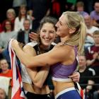 Silver medallist Eliza McCartney, of New Zealand (left), embraces gold medallist and training...