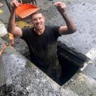 Dunedin man Andrew James stands in a North Dunedin drain holding his friend’s wedding ring....