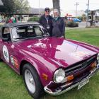Magenta machine... Auckland couple Murray and Steph Booth stand next to their 1973 Triumph TR6,...