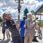 Former professional road cycling champion Julian Dean (left) enjoys a story told by his...