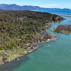 Whitebait stands at the Arawhata River mouth with Neil’s Beach and Jacksons Bay behind. PHOTO:...