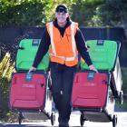 Dunedin City Council contractor Vincenz Binder helps deliver the new council recycling bins in St...