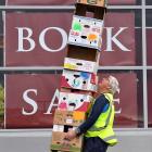 Task Force Green supervisor Andrew Maton carries away a tower of empty boxes following the most...