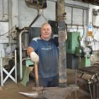 Brown &amp; Cope owner Wayne Sheridan forges a leaf plate from the suspension system of an...