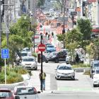 People and cars negotiate George St, central Dunedin, yesterday. Retailers in the area say they...
