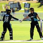 Suzie Bates of New Zealand shakes hands with Brooke Halliday after scoring a half century during...