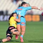 Amy du Plessis of Matatu offloads the ball during her side’s round five Super Rugby Aupiki match...