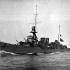 British light cruiser HMS Dunedin, pictured in fighting trim with all guns trained and cruising...