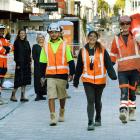 Construction workers (front from left) Talia Walsh, Hayley Poni and Marty McDonnell strut down...