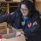 Jacqui Te Wani helps pack food parcels for the Ōtautahi Māori Wardens. Photo: Supplied