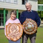 Alison and Neville Ludemann hold up the Rose Ranfurly and Mills Shield at the Maheno Bowing Club...