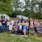 Surrounded by family members, three of the four remaining grandchildren of James Bowen Sim, Ron...