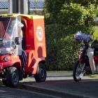 A New Zealand Post postie chats to a DX mail delivery person shortly after the news of NZ Post’s...