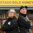 Otago Gold Honey owners Carlee McCaw and Tom Sinclair stand in front of their honey stall...