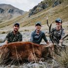 Posing with a stag in the Remarkables range in 2022 are (from left) Brodie Green and James and...