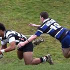 Southern loose forward Konrad Toleafoa scores a try in front of Kaikorai defender Troy Anstiss at...