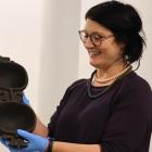 Tūhura Otago Museum collection manager, humanities, Anne Harlow shows an object from Fiji...