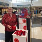 Golden Centre manager Nina Rivett holds some of the hundreds of hand-made poppies, created by...