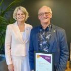 Business Mentors New Zealand chief executive Sarah Trotman congratulates mentor Mike Henderson,...