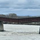 A rail bridge over the Rangitata River, South Canterbury, sags after flood water washed away one...