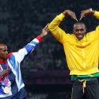 Jamaica's Usain Bolt celebrates with Britain's Mo Farah on the podium after each receiving gold...
