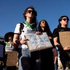 Protesters take part in a rally led by Women's March Tucson after Arizona's Supreme Court revived...