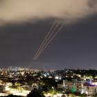 An anti-missile system operates after Iran launched drones and missiles towards Israel, as seen...