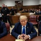 Former US president Donald Trump sits in court on the first day of opening statements in his...