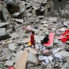 Palestinian children inspect the site of an Israeli strike on a house in Rafah, in the southern...