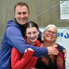 Swimmer Anna Harrex is hugged by her parents Andrew and Christine.