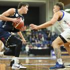  Otago Nuggets guard Ben Henshall eyes his options against Wellington Saints defender Hyrum...