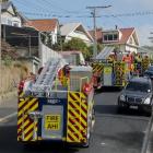Fire trucks line the hill in Embo St as crews respond to a fire at a property in the street....